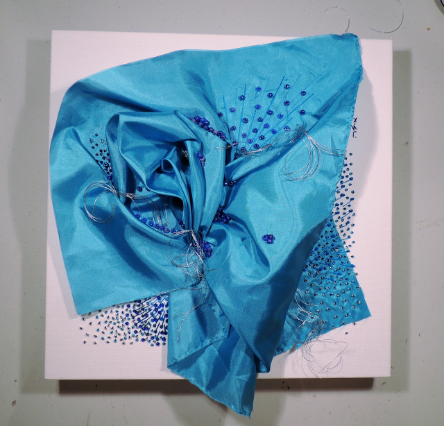 A piece of blue cloth is sitting on a white surface