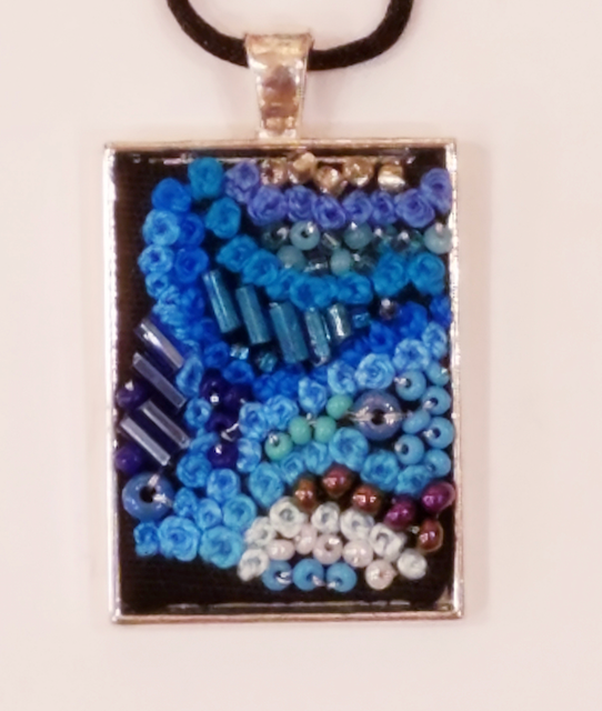 A necklace with blue and white beads on it