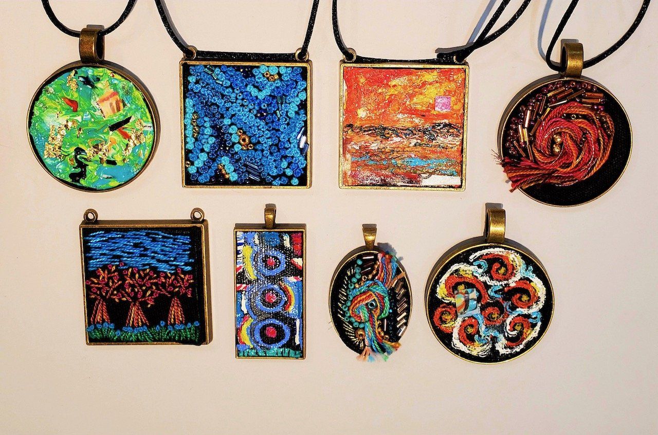 A group of necklaces with different designs on them