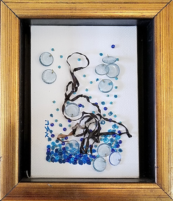 A framed painting with bubbles and a drawing of a person