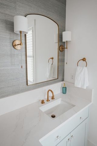 A Bathroom With A Sink, Mirror, And Lamp - Countertop Specialists in Savannah, GA