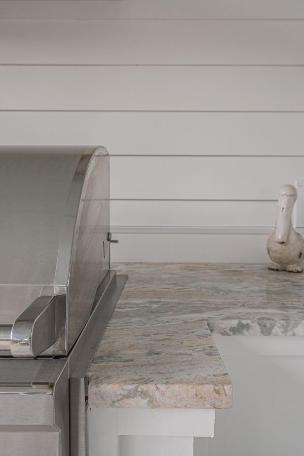 A Stainless Steel Grill Is Sitting On Top Of A Granite Counter In A Kitchen - Countertop Specialists in Savannah, GA