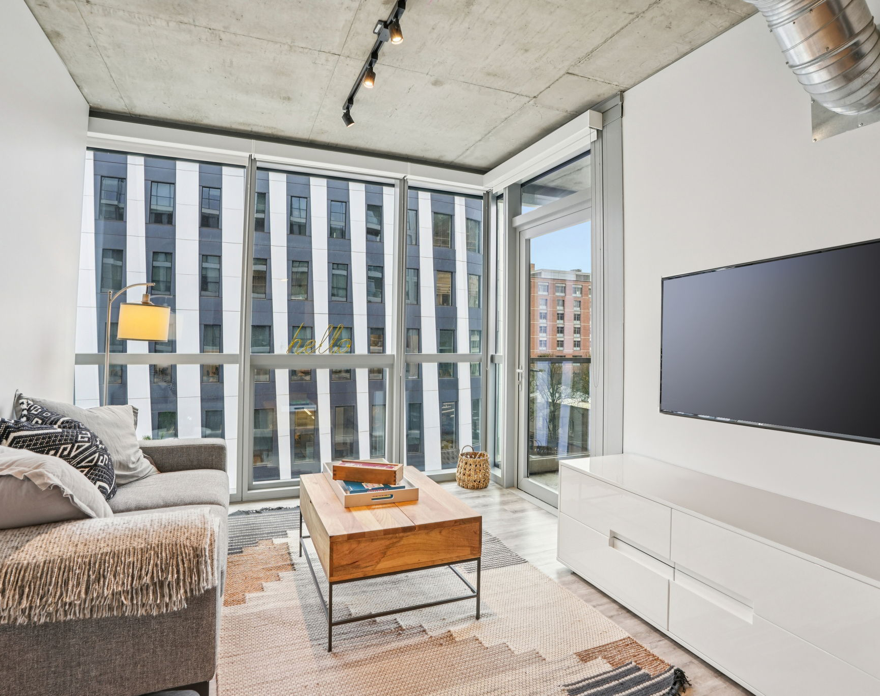 living room with large windows and balcony