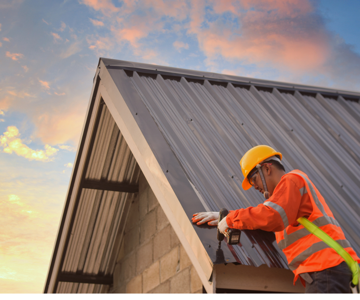 A man is working on the roof of a building