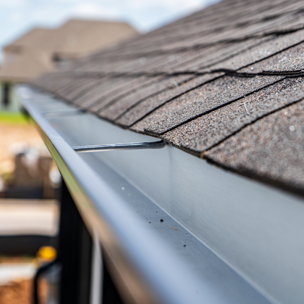 A close up of a gutter on the roof of a house.