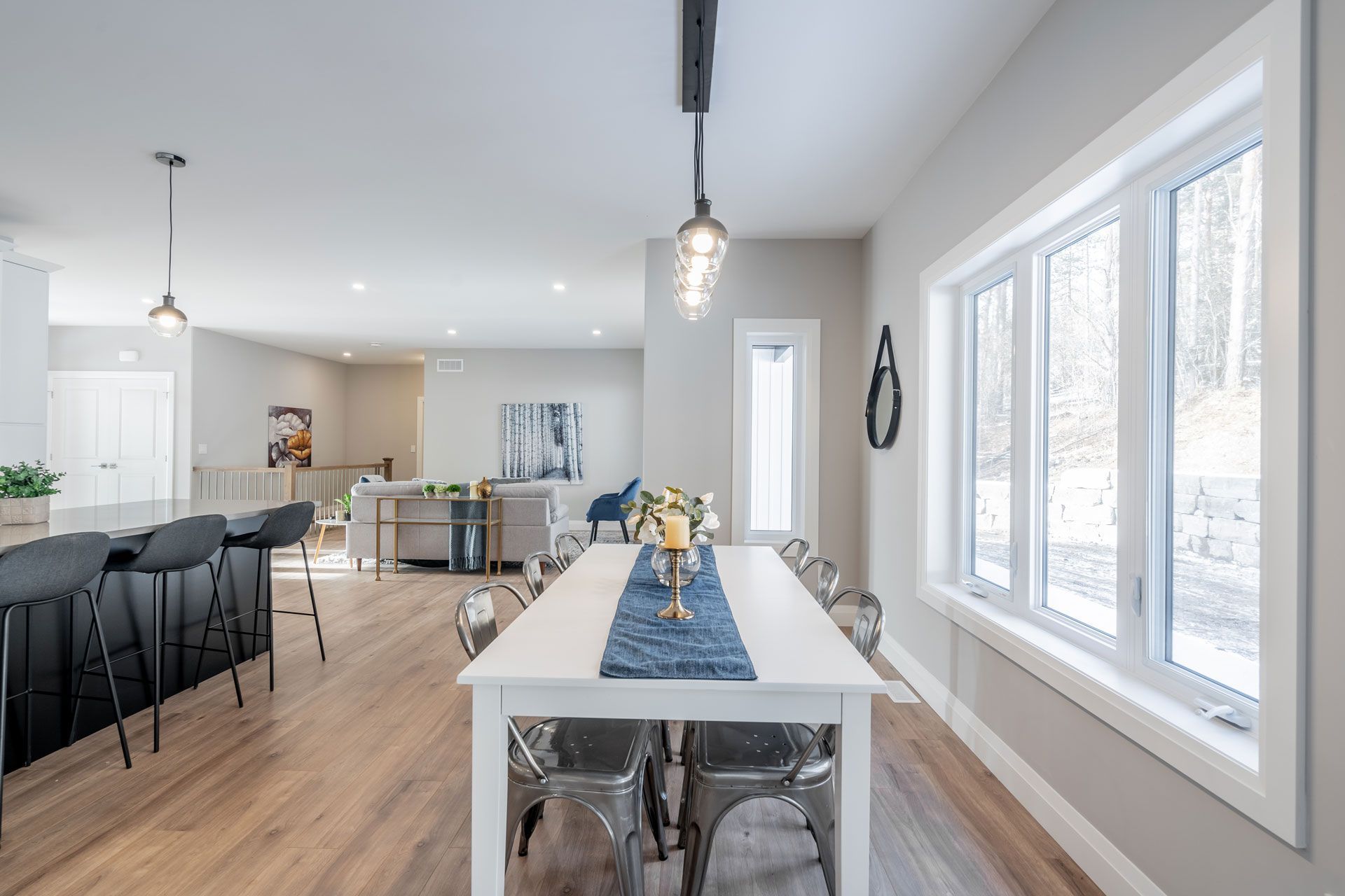 A dining room table with a blue table runner on it in a Fidelity Homes Signature build in Cramahe Township