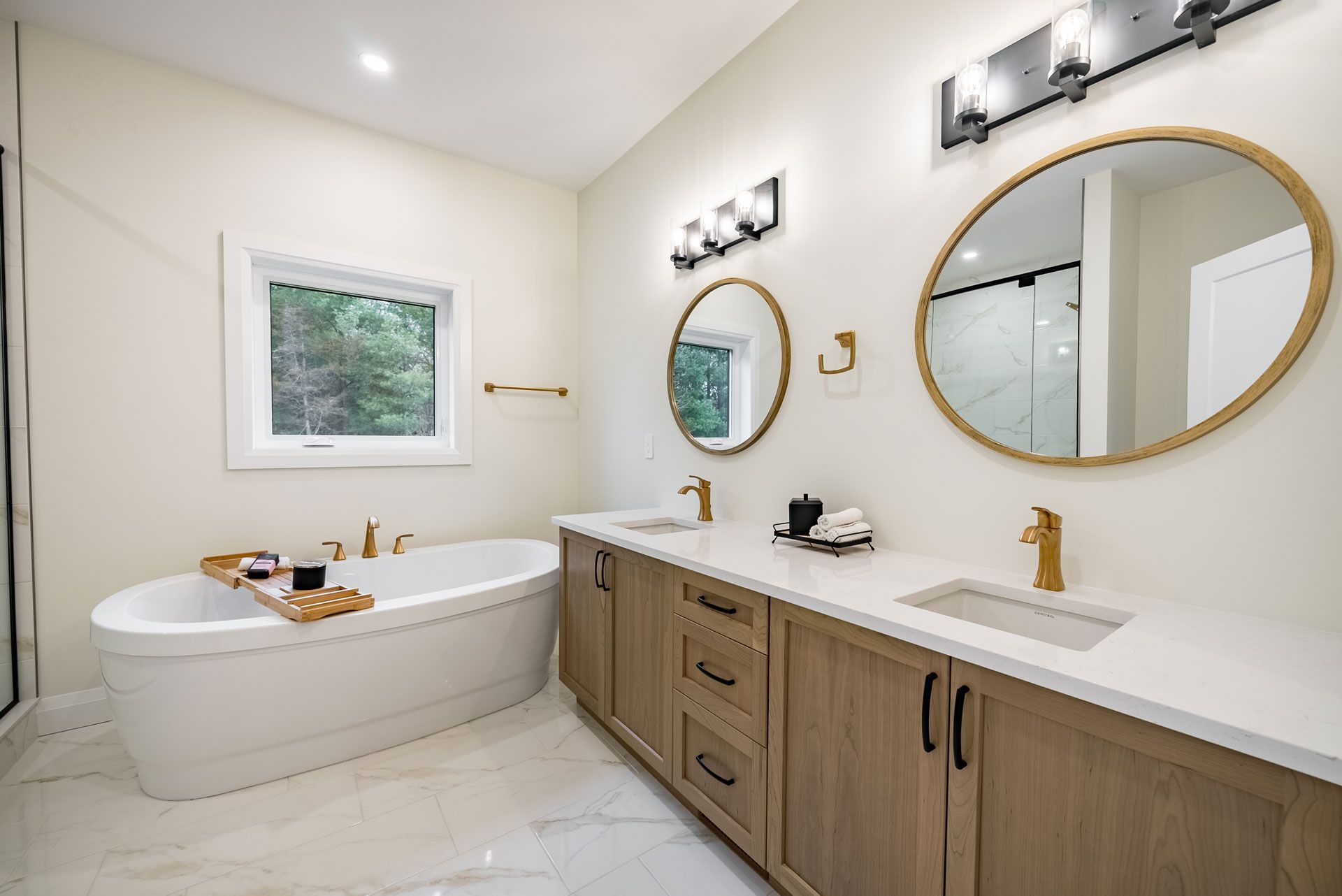 A bathroom with a bathtub and two sinks in Fidelity Homes Signature build in Cramahe Township