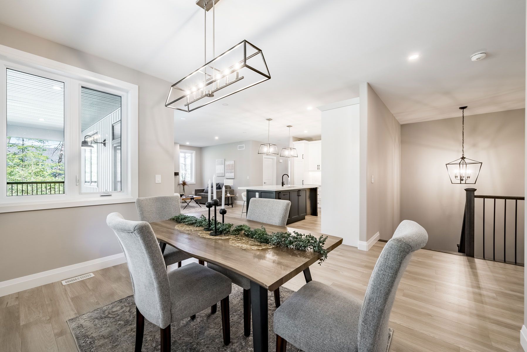 A dining room with a wooden table and chairs Fidelity Homes Signature build in Cramahe Township