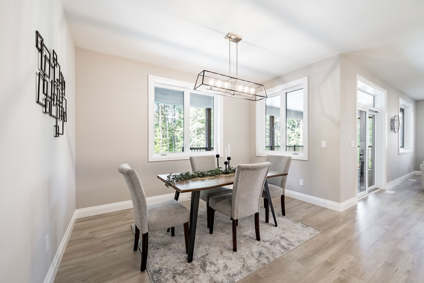 A dining room with a table and chairs and a chandelier Fidelity Homes Signature build in Cramahe Township