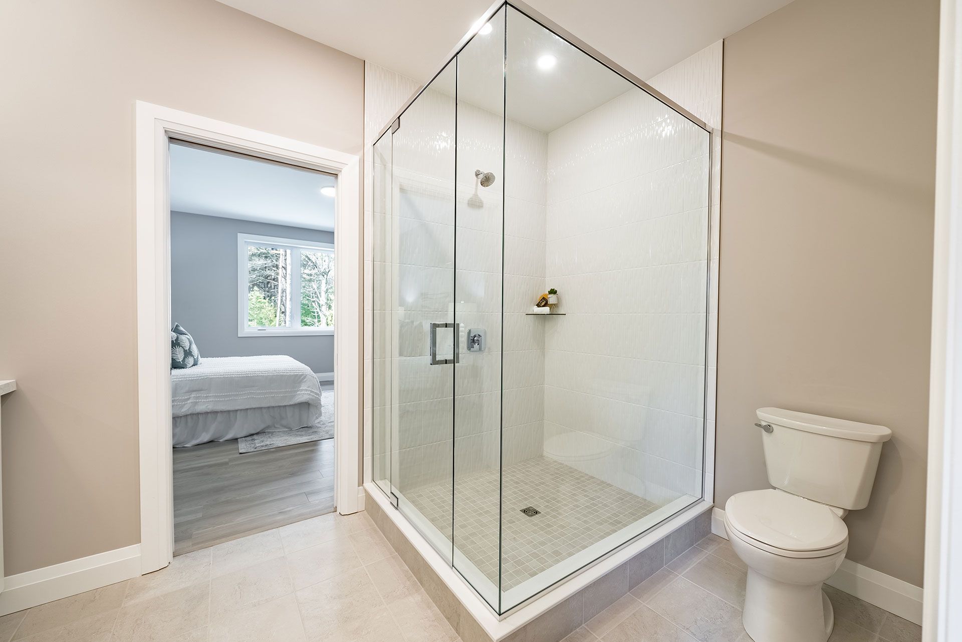 A bathroom with a walk in shower and a toilet in Fidelity Homes Signature build in Cramahe Township