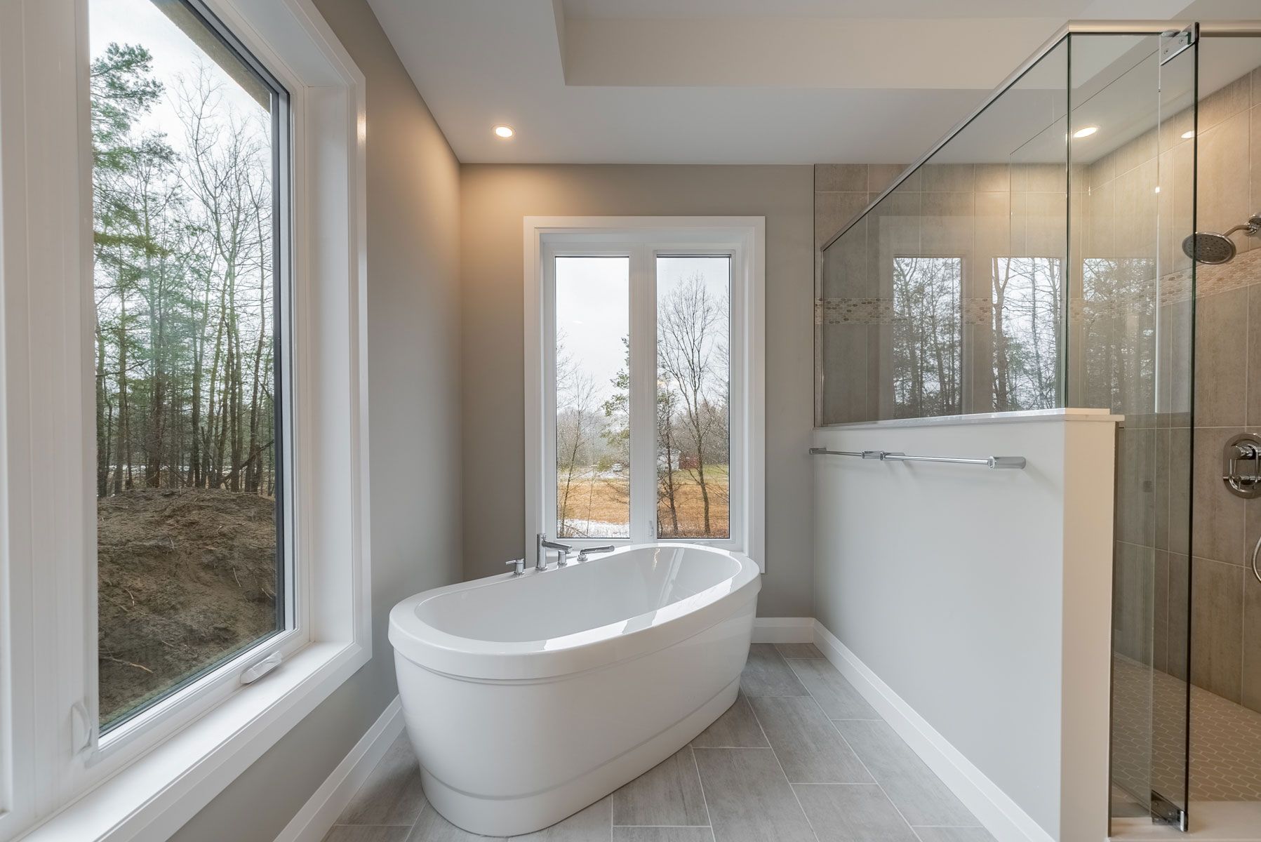 A bathroom with a bathtub and a shower in Fidelity Homes Signature build in Castleton