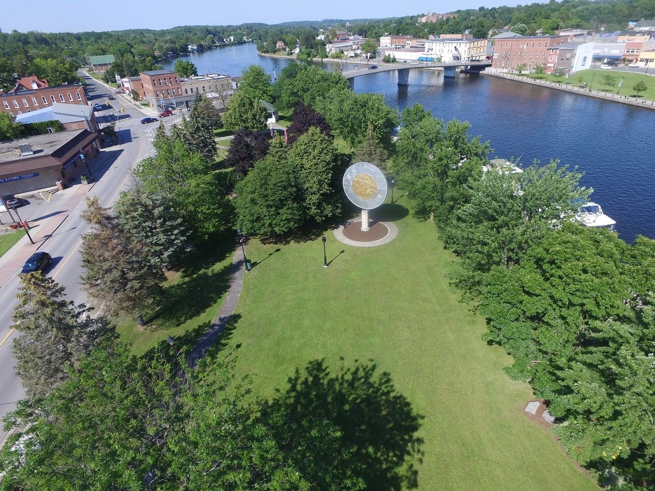 A view of the Trent River surrounded by trees and rocks on a sunny day with
the Giant Toonie