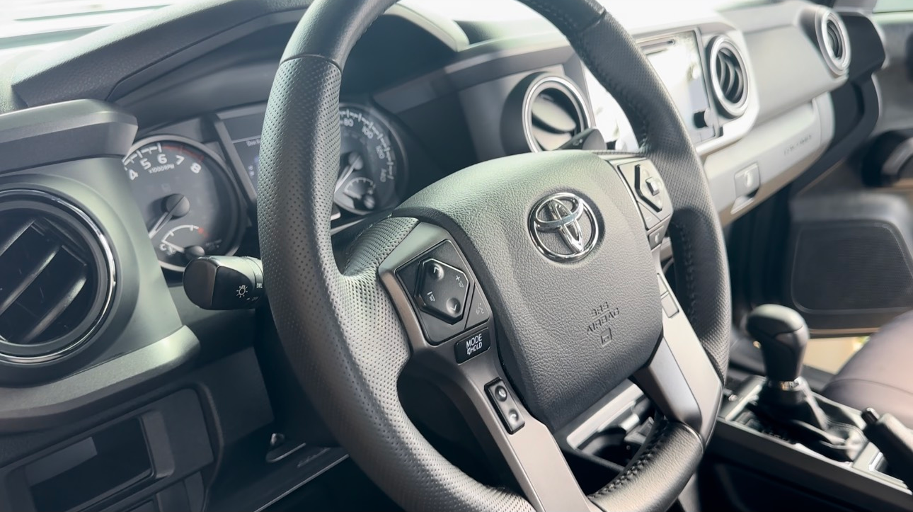 A close up of a steering wheel in a car