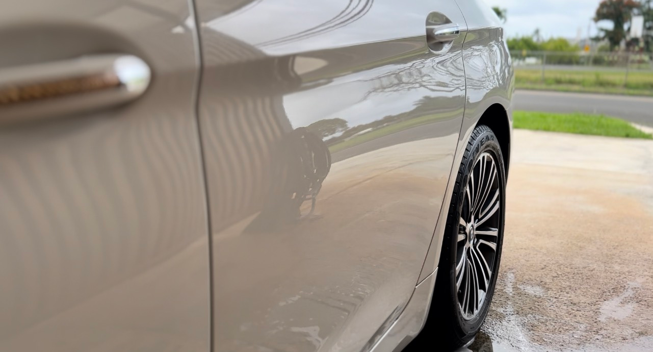 A close up of a car parked on the side of the road.