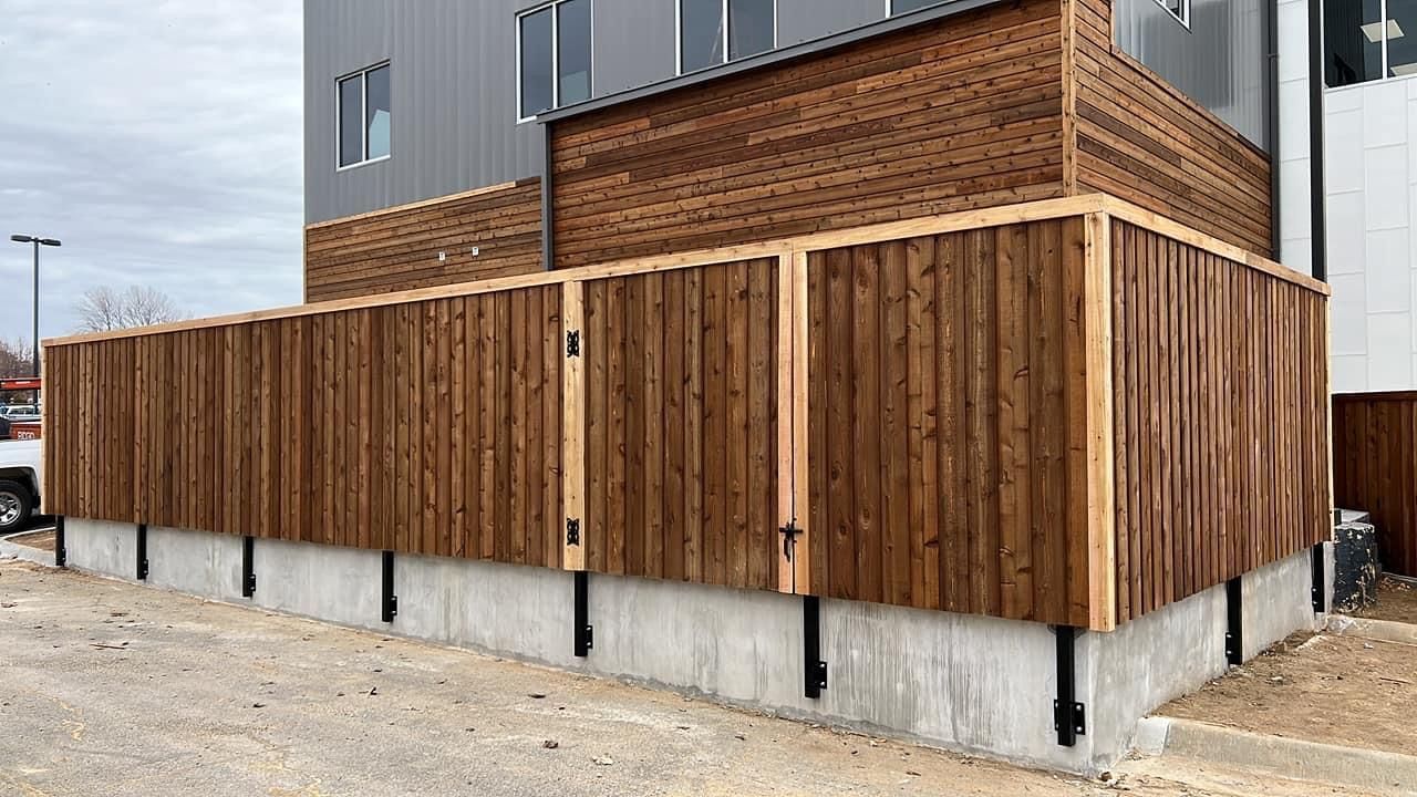A wooden fence is being built on the side of a building.