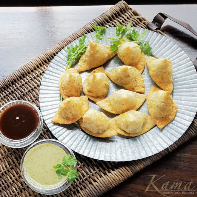 Hand folded from scratch made savory pastries filled with spiced potatoes and peas