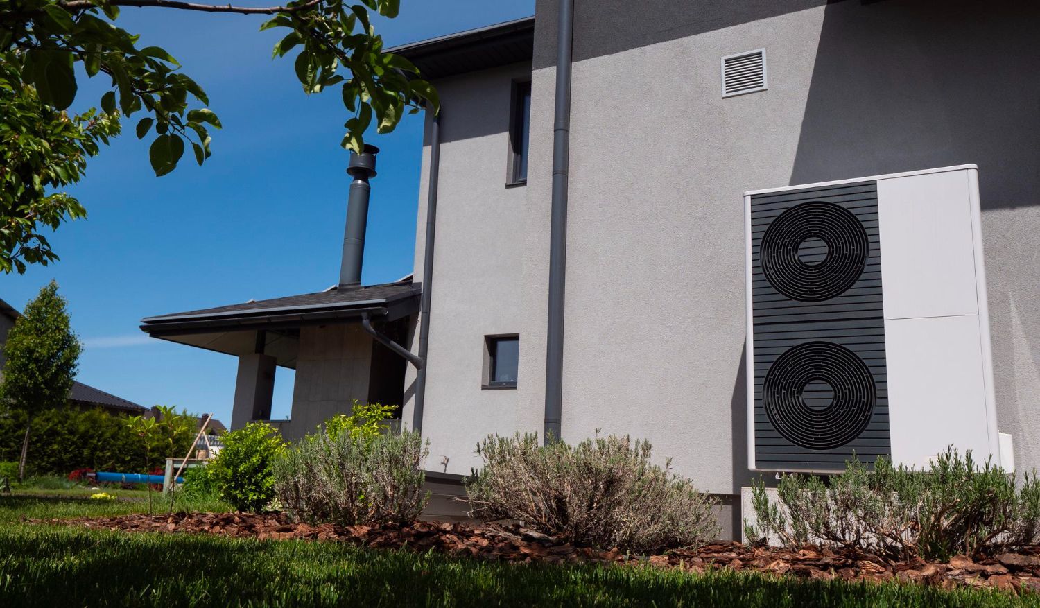 A house with a large air conditioner on the side of it.