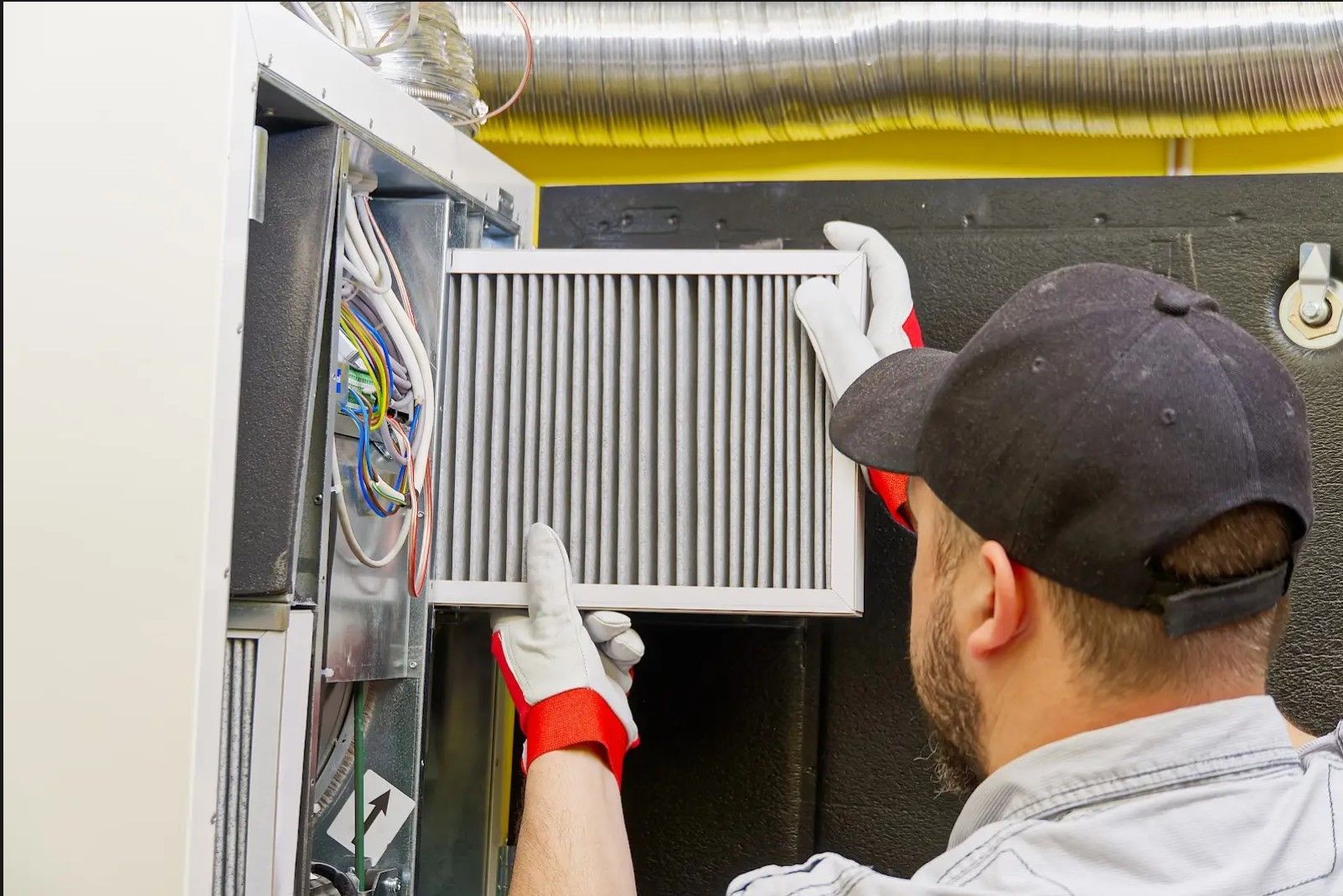A man is holding a filter in front of a machine.