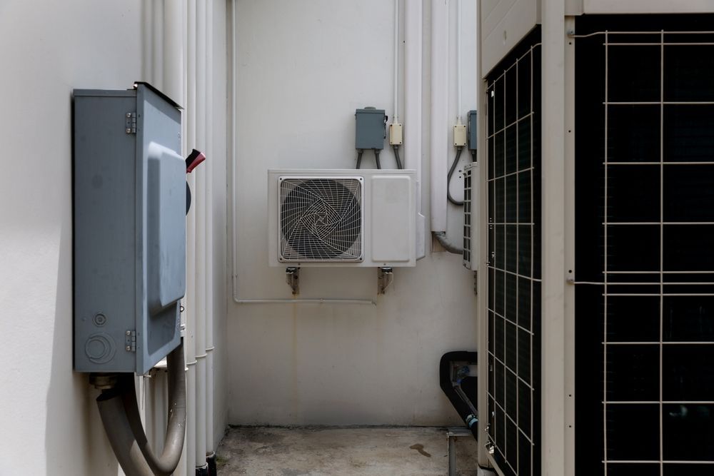 An air conditioner is mounted on the side of a building.