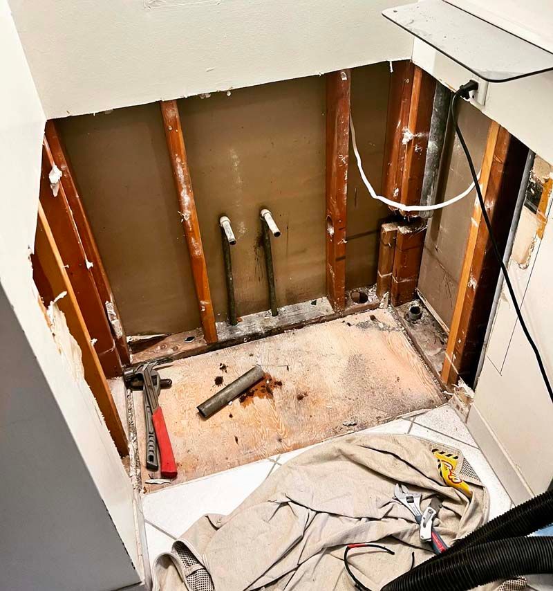 A bathroom under construction with a hole in the wall