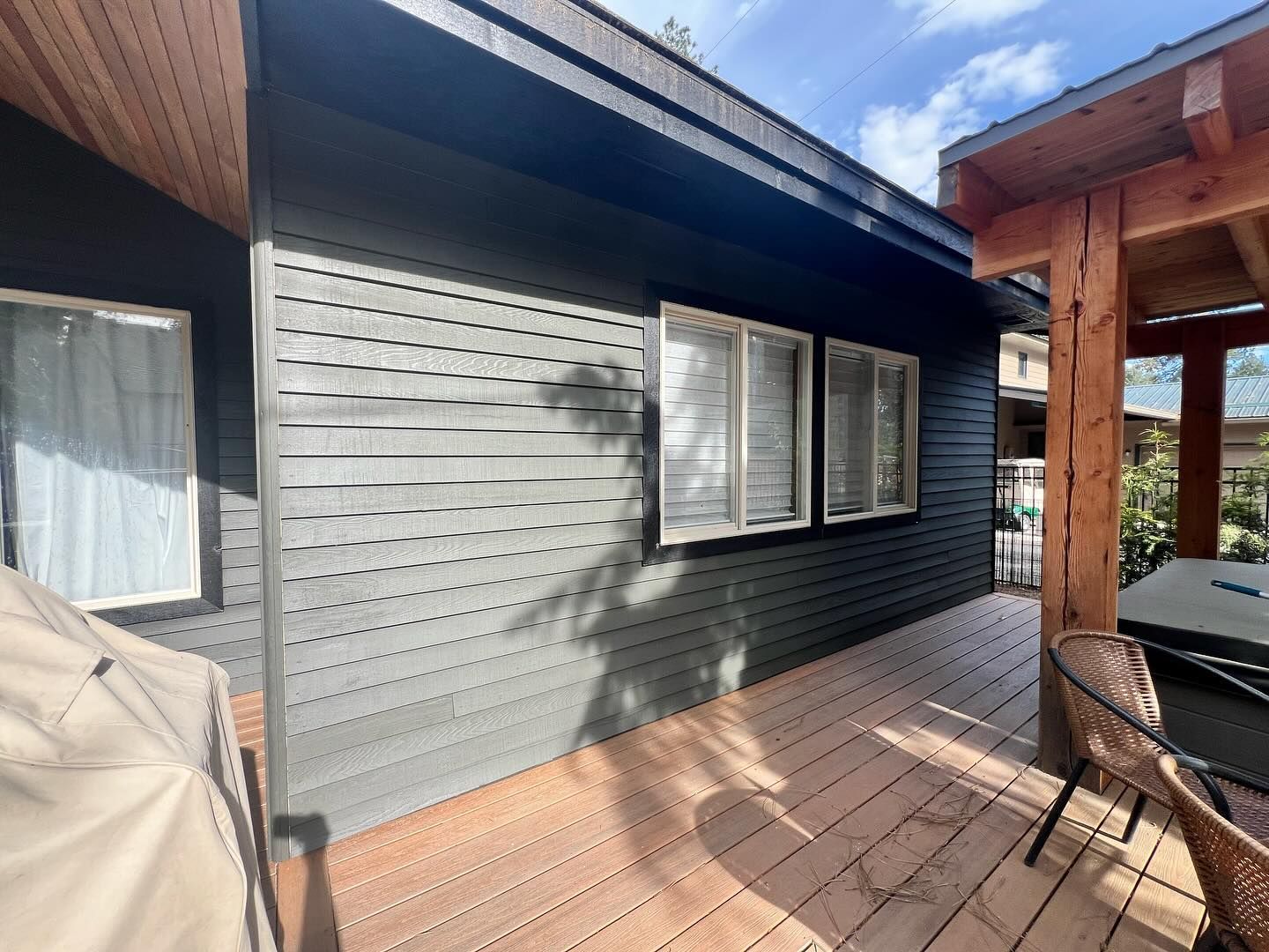 A house with a large deck and a grill on it.