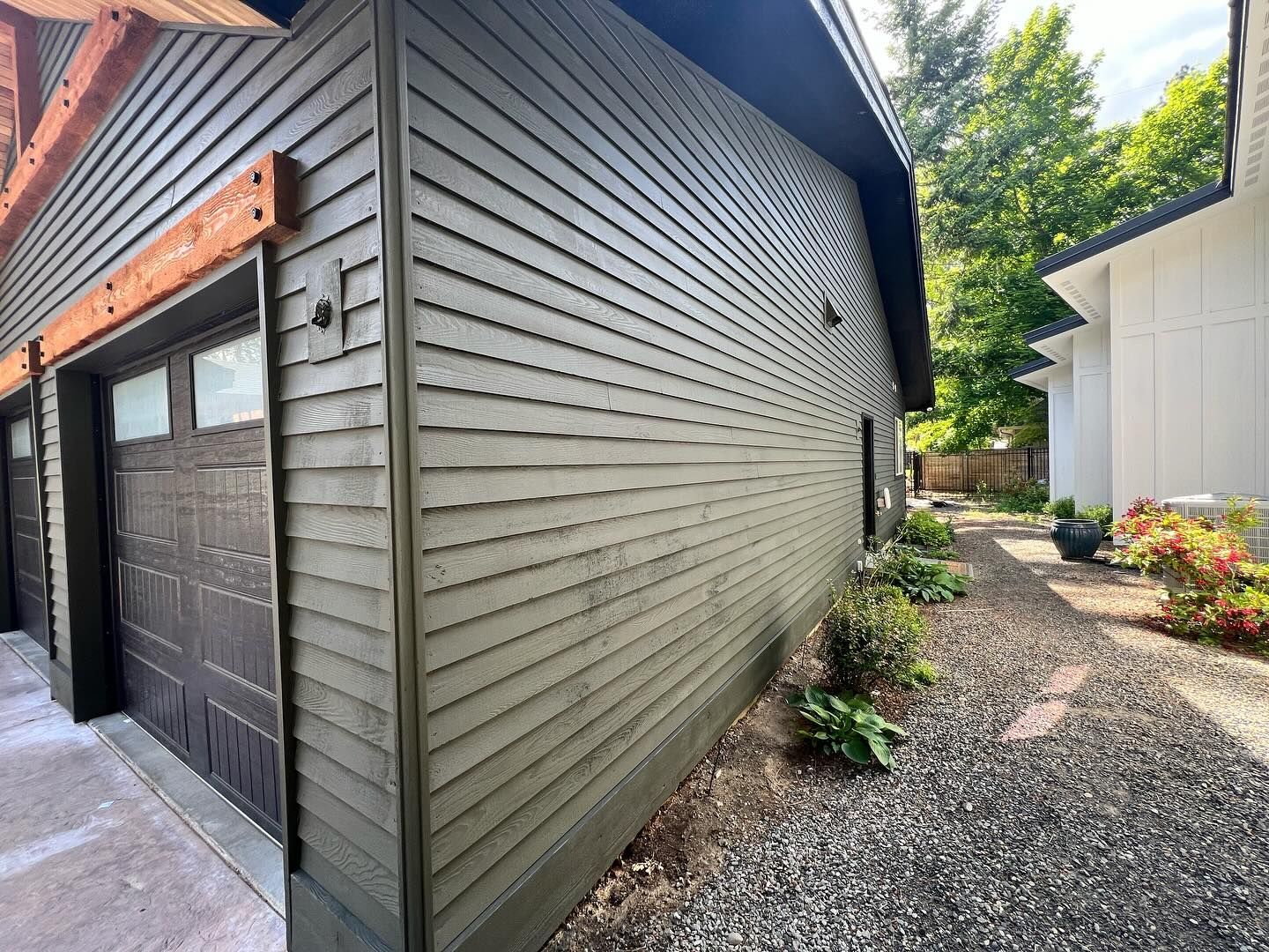 The side of a house with a garage and a driveway.