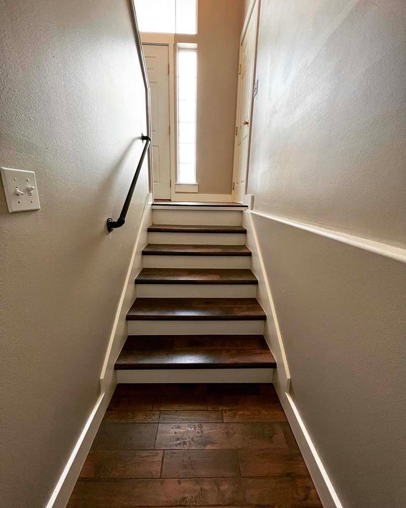 A set of stairs leading up to a doorway in a house.