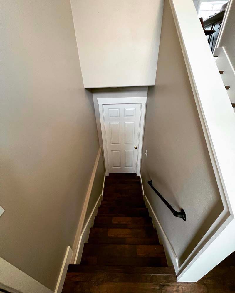 A staircase leading up to a door in a house.