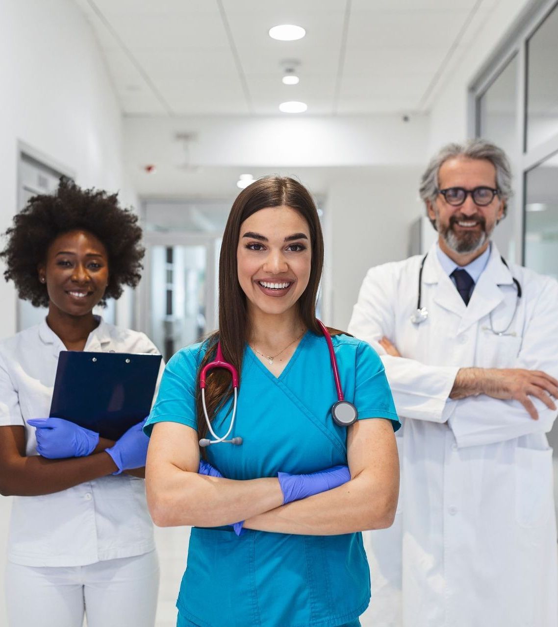 A group of doctors and nurses are posing for a picture