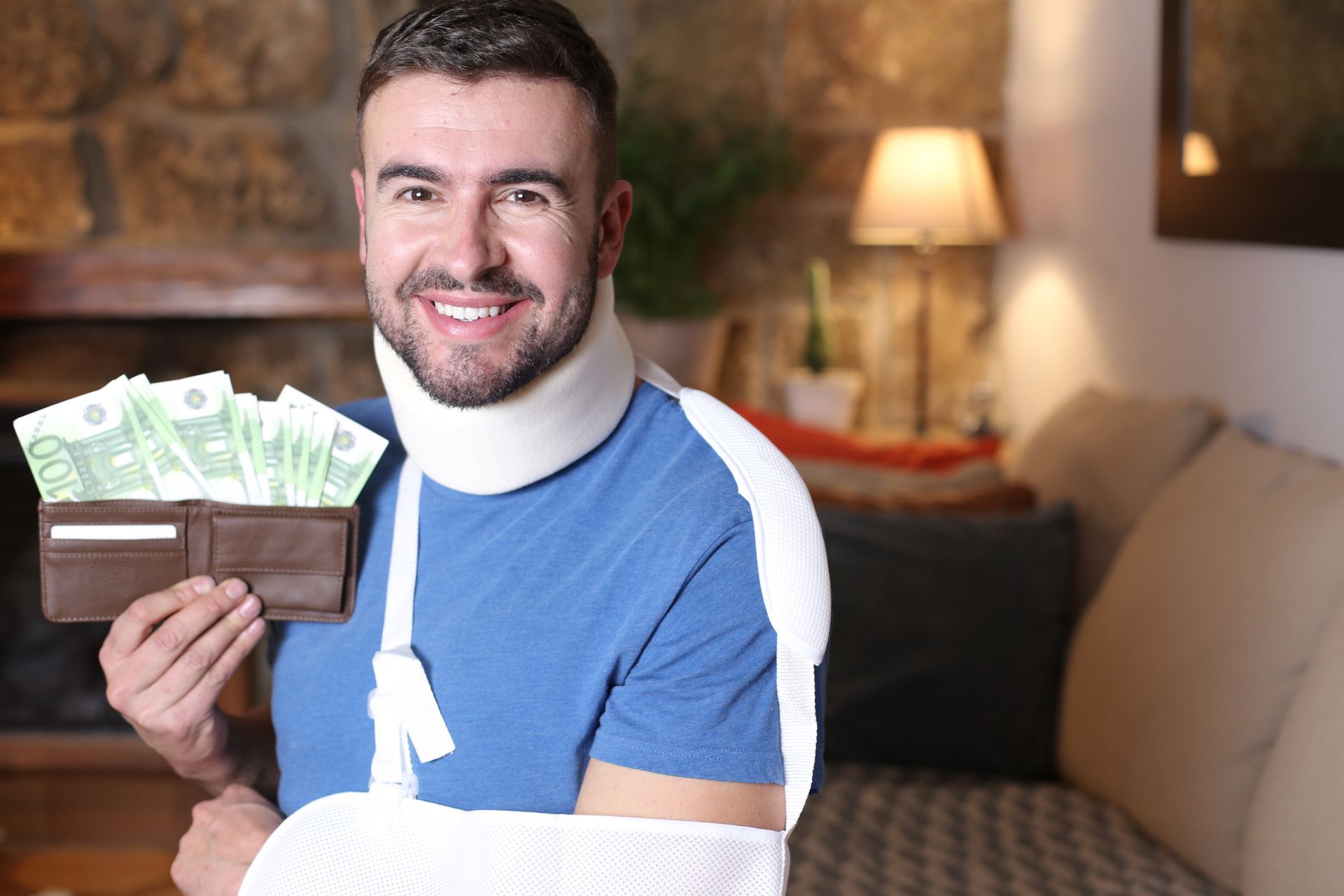 A man with a broken arm is holding a wallet full of money.