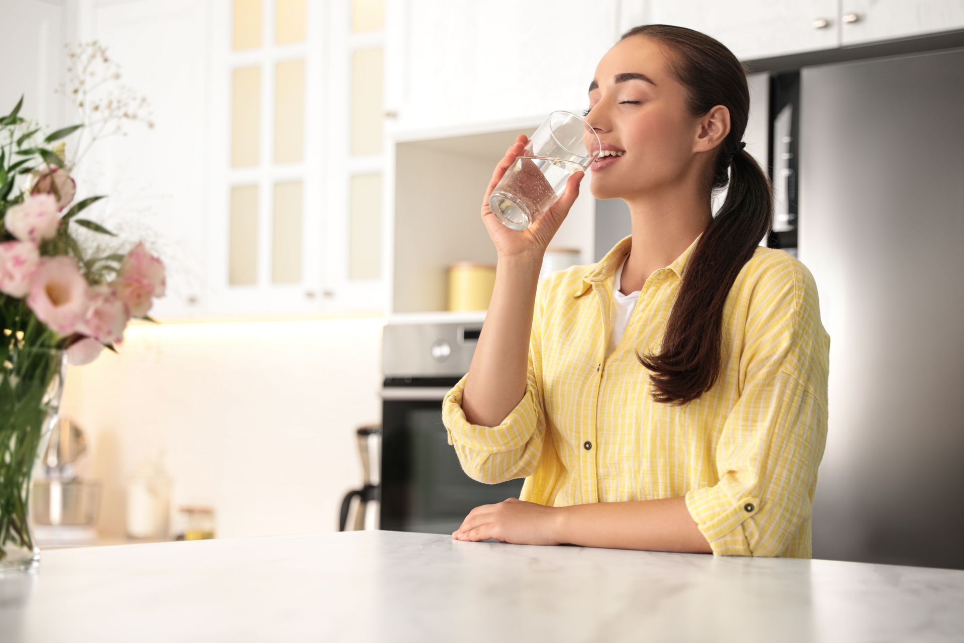 young woman drinking pure water glass