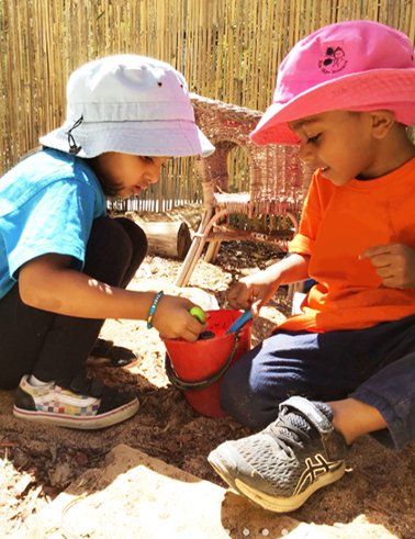 Two Kids playing in the Sandpit — About Us In Alice Springs, NT