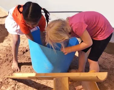 Children playing with blue bucket — About Us In Alice Springs, NT