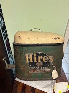 Vintage Hires Root Beer cooler, green and beige, with a spigot and handle.