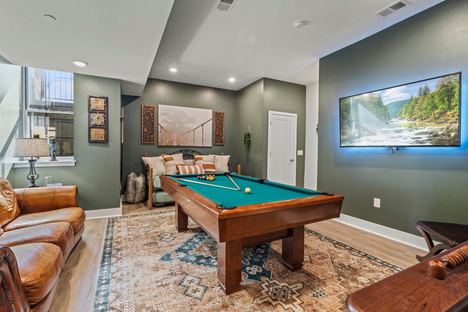 There is a pool table in the middle of the room.