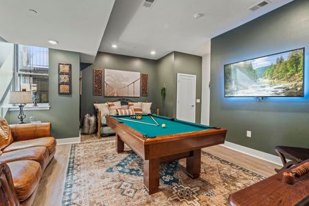 There is a pool table in the middle of the room.