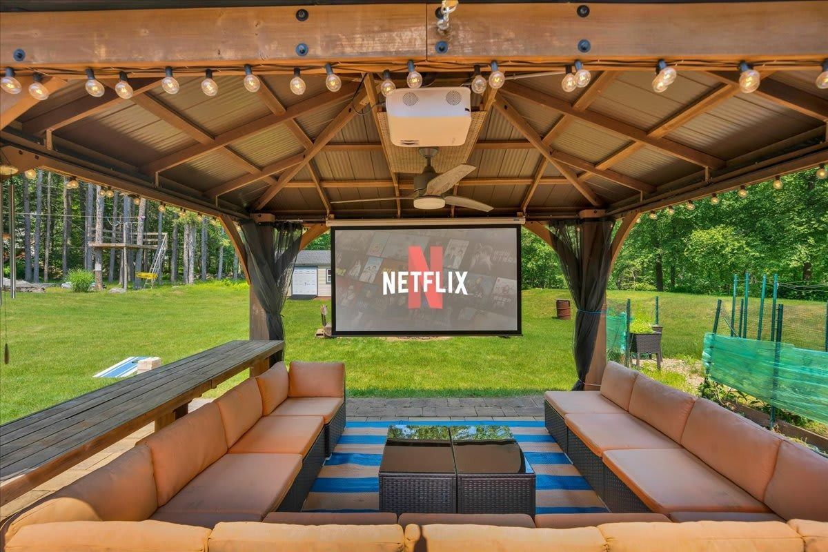 A gazebo with a projector screen that says netflix on it.