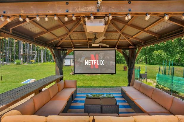A gazebo with a projector screen that says netflix on it.