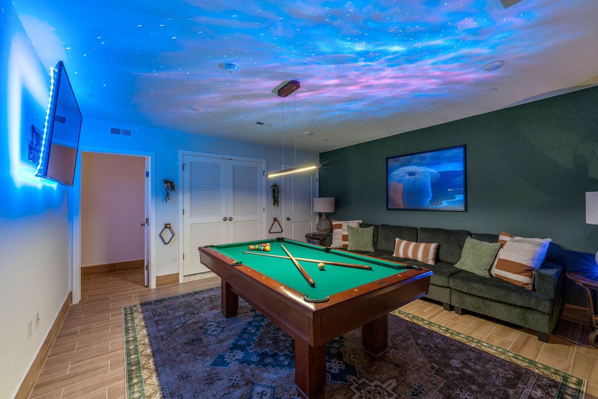 There is a pool table in the middle of the room.
