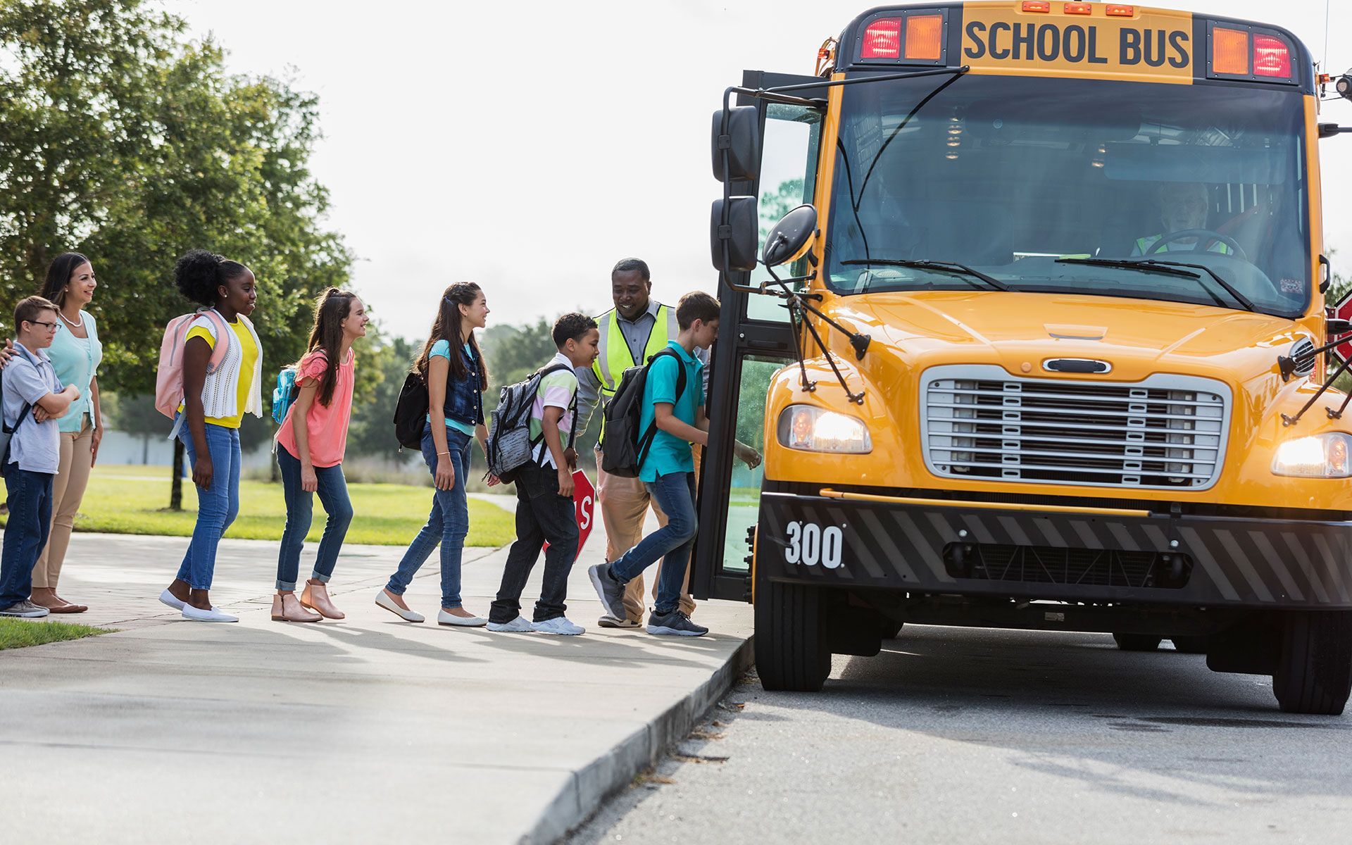 A group of children are boarding a school bus.