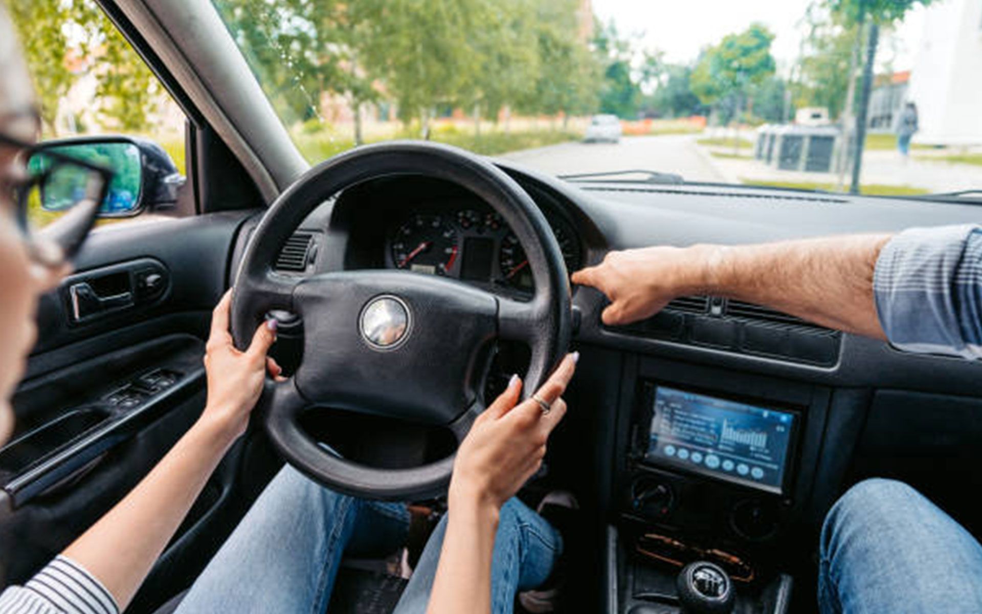 A man and a woman are driving a car.