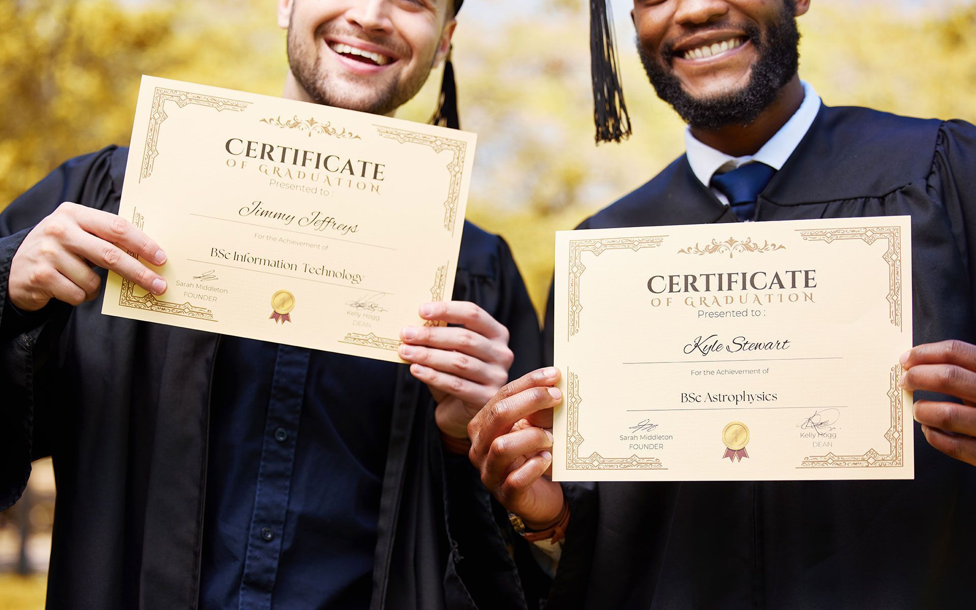 Two men in graduation gowns are holding up their certificates.
