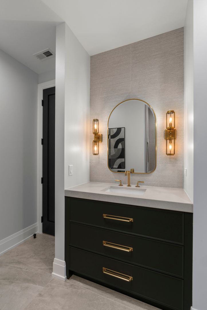 A bathroom with a sink , mirror and dresser.