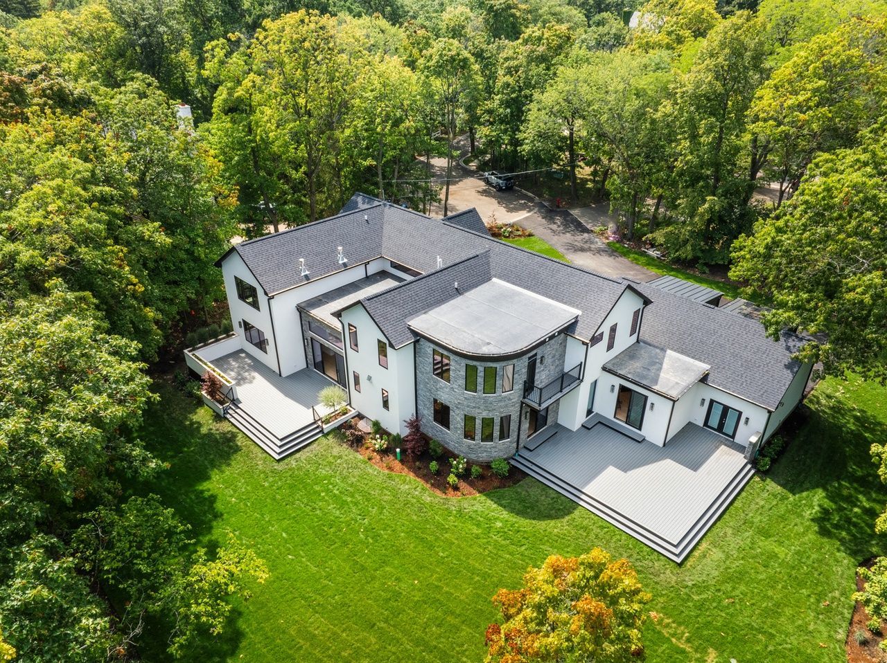 An aerial view of a large house surrounded by trees.
