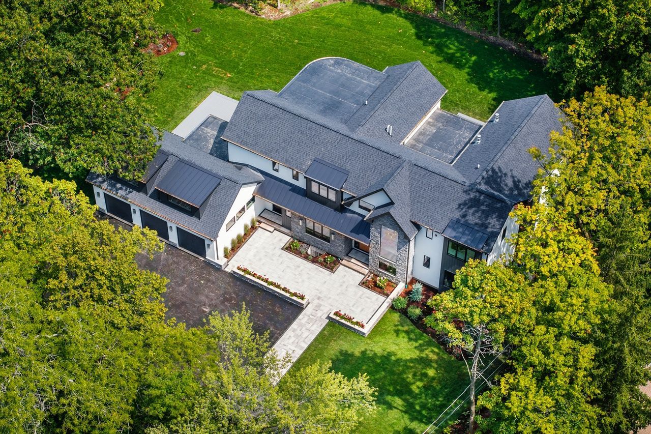 An aerial view of a large house surrounded by trees.