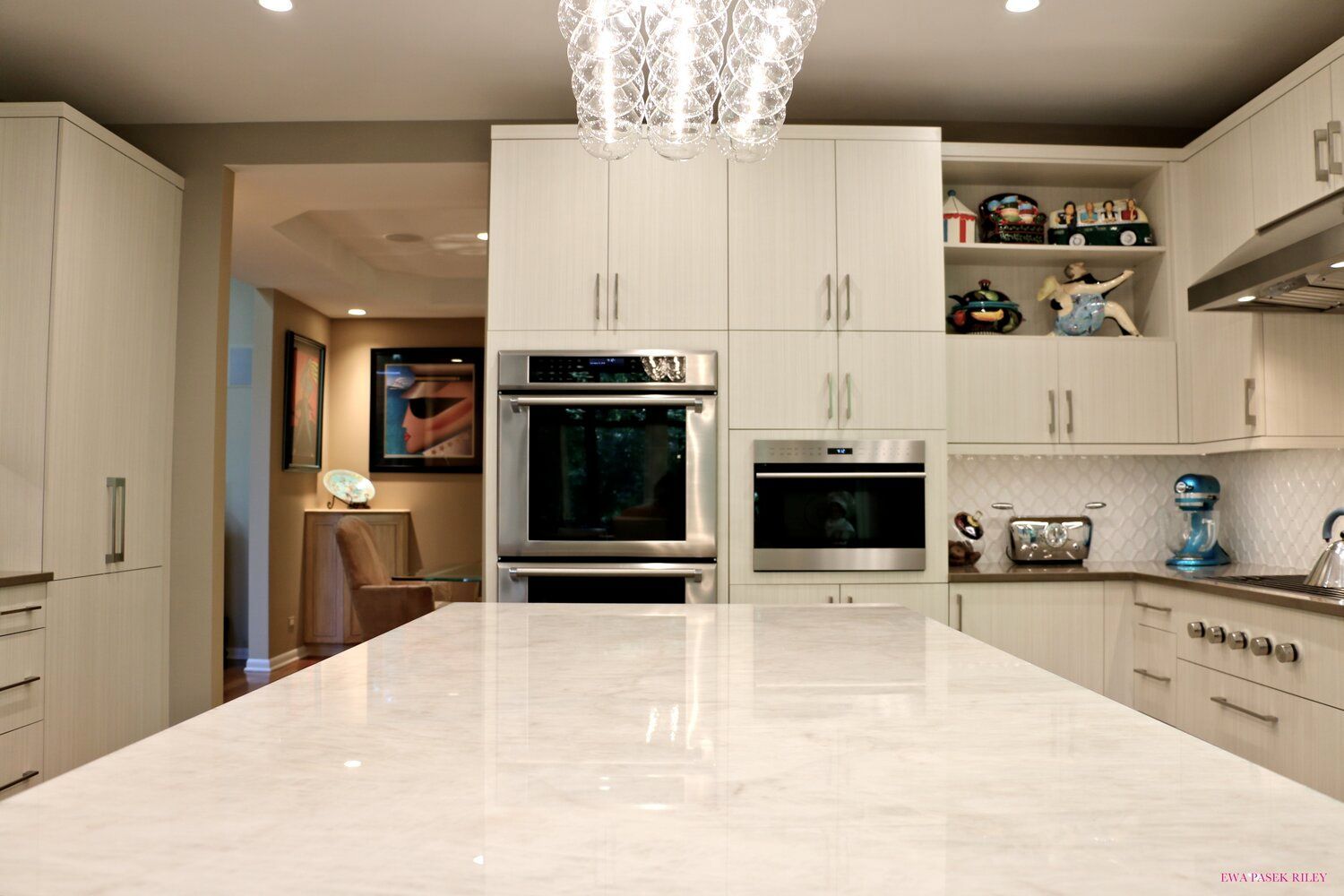 A kitchen with white cabinets and stainless steel appliances