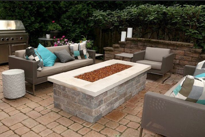 There is a fire pit in the middle of the patio.