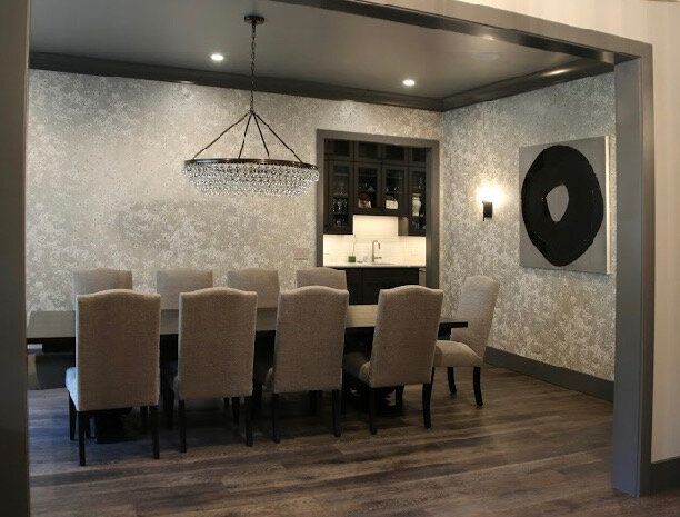 A dining room with a long table and chairs