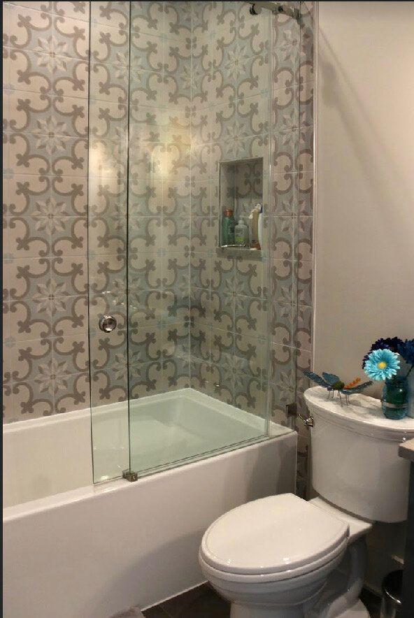 A bathroom with a toilet , bathtub and shower.