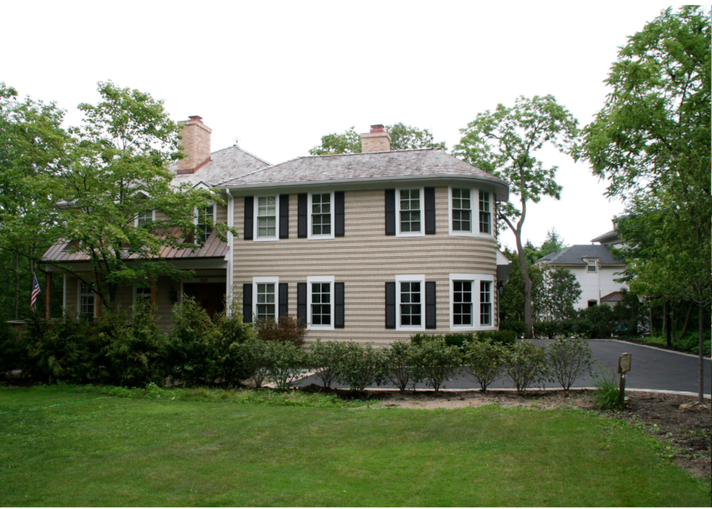 A house with a lot of windows and black shutters